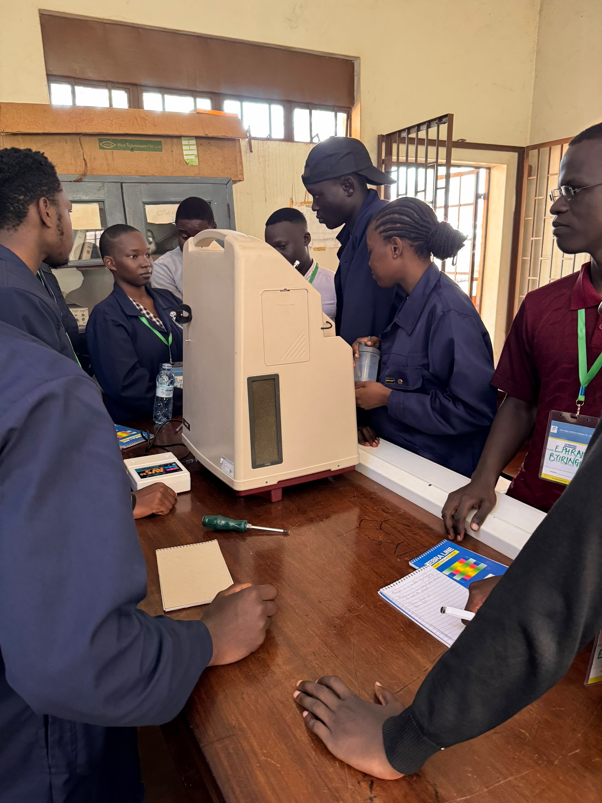 Students working hands-on with an oxygen concentrator