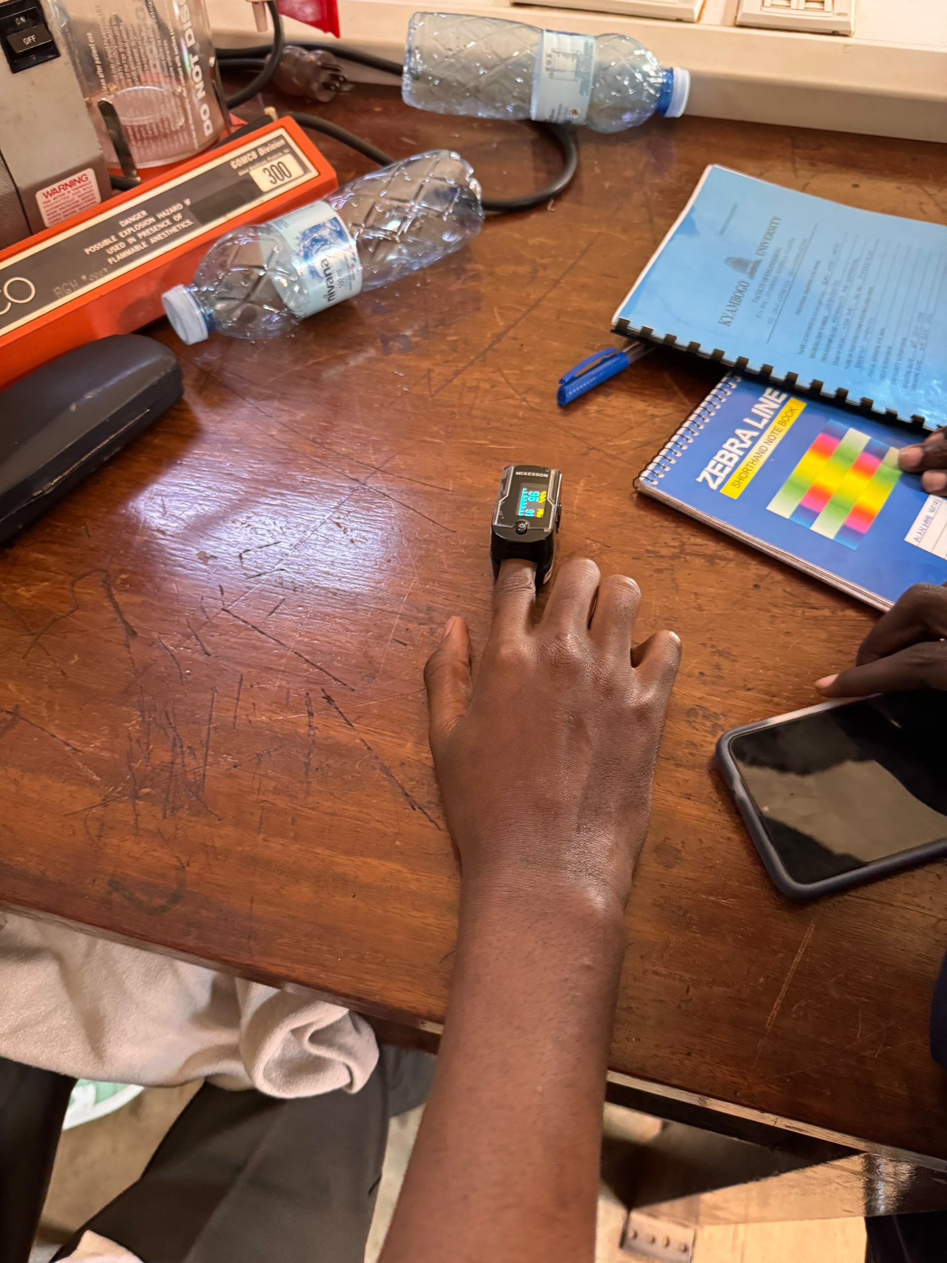 A student learning to use a pulse oximeter